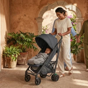 mom pushing full-size baby stroller on garden